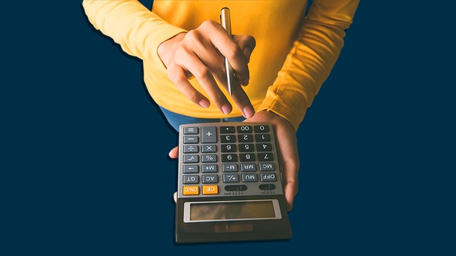 woman holding calculator and pen